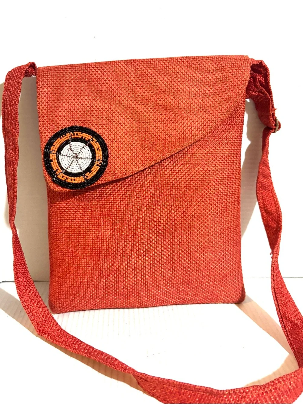 Handwoven Orange Crossbody Bag with Beaded Accent